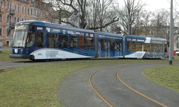 A tram blue and white in a turning loop.
