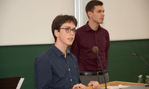Two young men stand at the lectern.