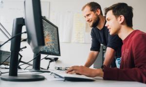 Two men looking at a monitor