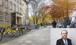 Gelbe Fahrräder vor einem Gebäude der TU Dresden. Unten rechts ein Porträt eines Mannes mit Bart.