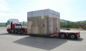 A truck with a large wooden box on the trailer