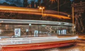 Tram runs through the city at night