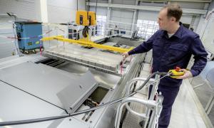 A man in a laboratory with car batteries.