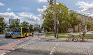 Road crossing with bus stop and cyclists
