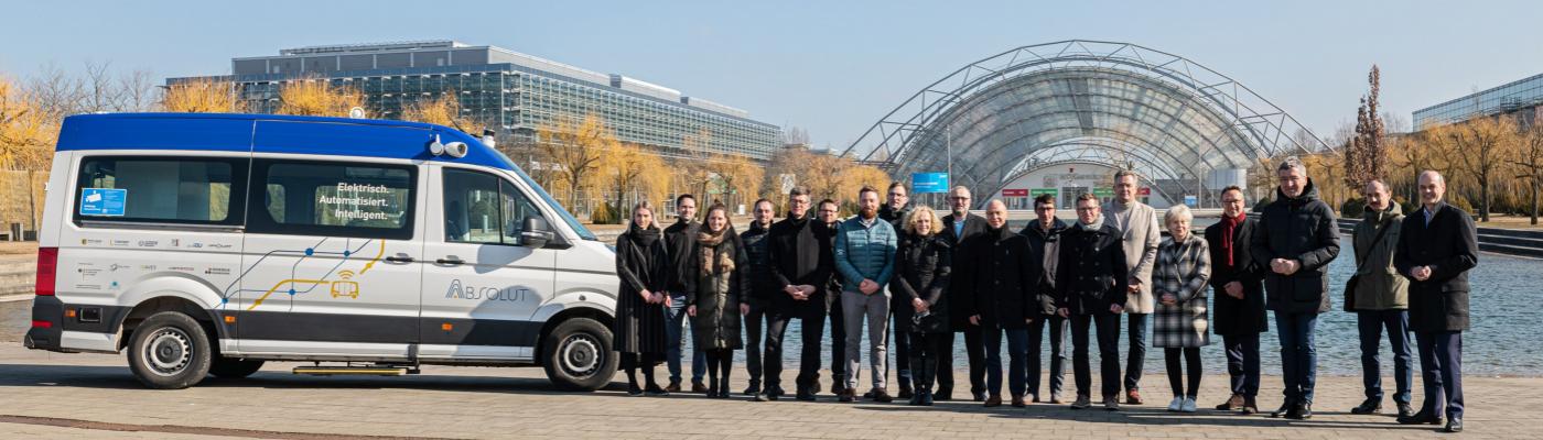 A group of people stand outside next to a van