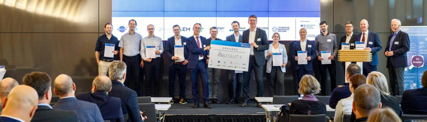 Group photo of all representatives of the ABSOLUT II project holding a funding certificate
