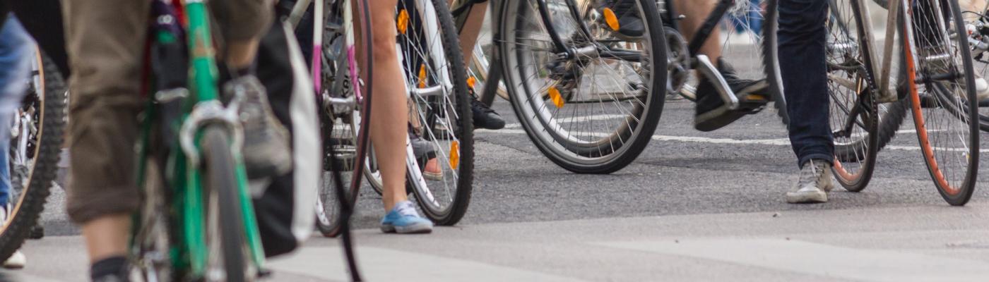 Serveral bycicles with people next to eachother