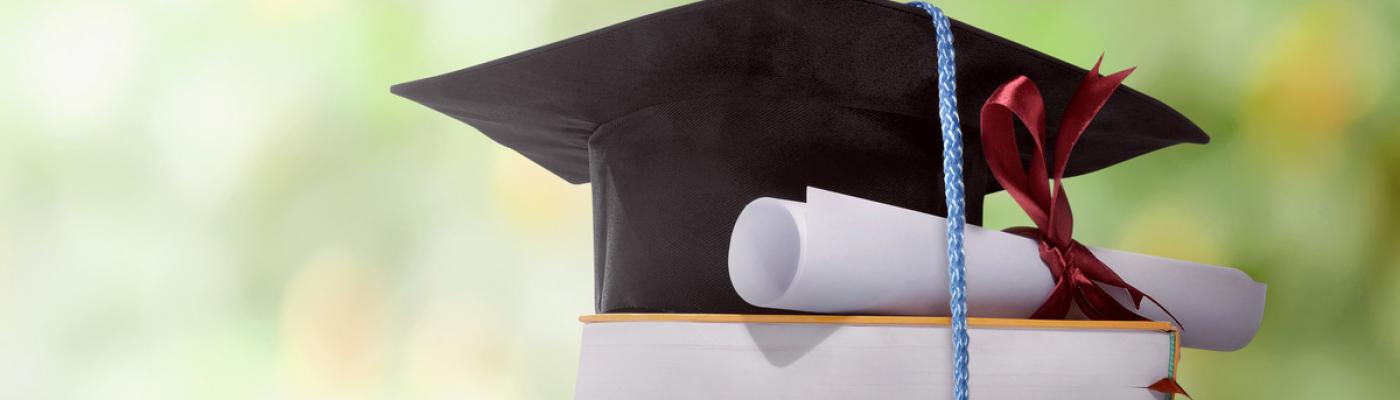 A graduation hat on books.