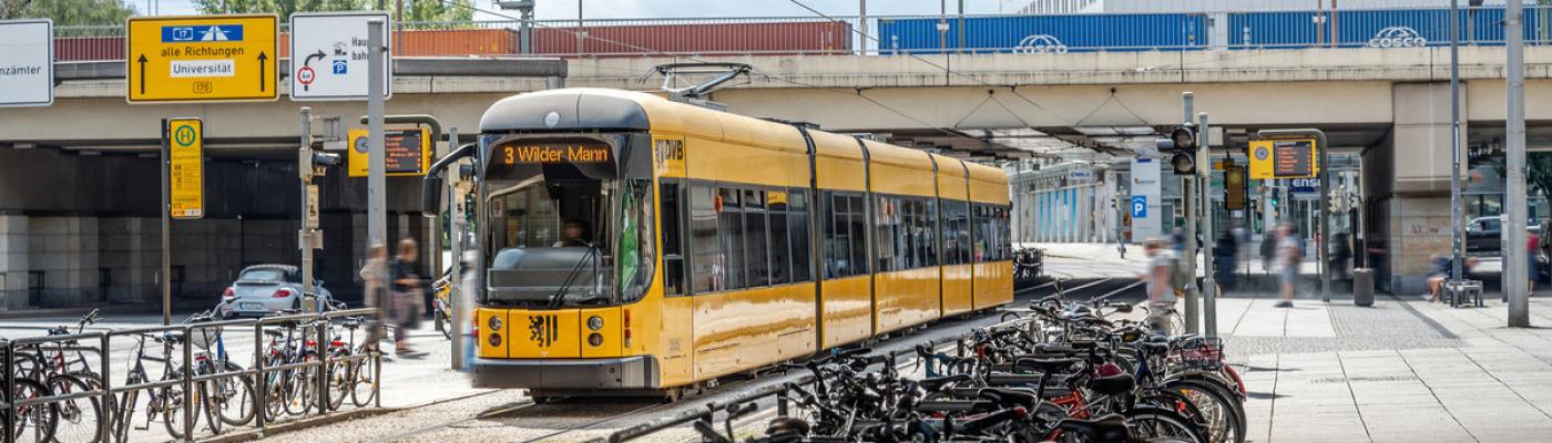 Photo of the infrastructure at the main station at the main entrance with many bicycles and the tram 