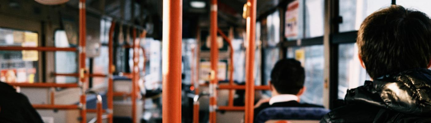 People sitting in a bus - view from the back