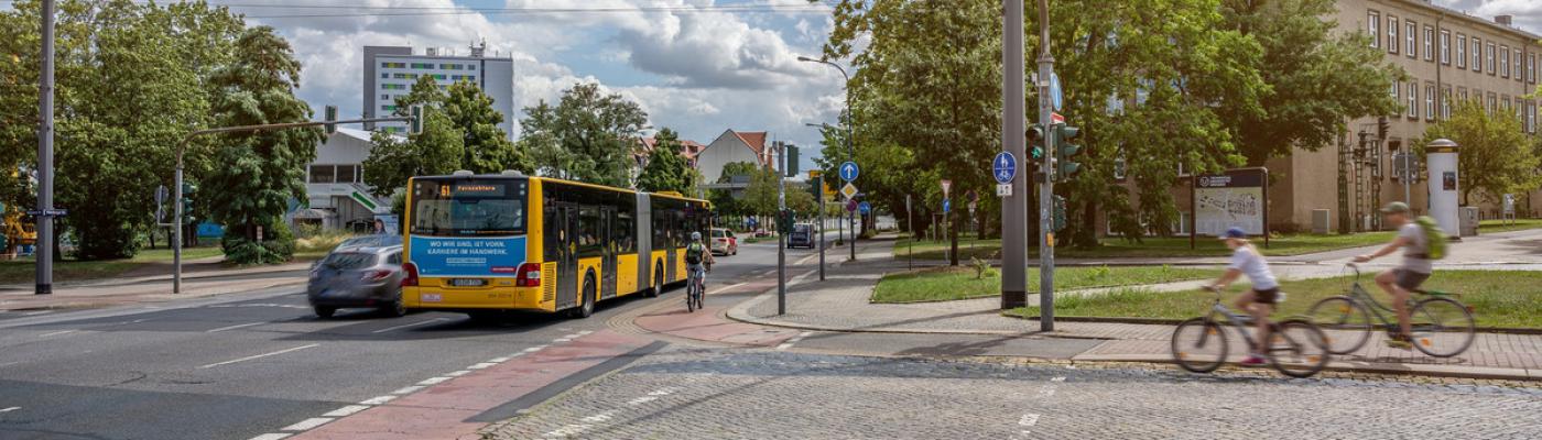 Road crossing with bus stop and cyclists